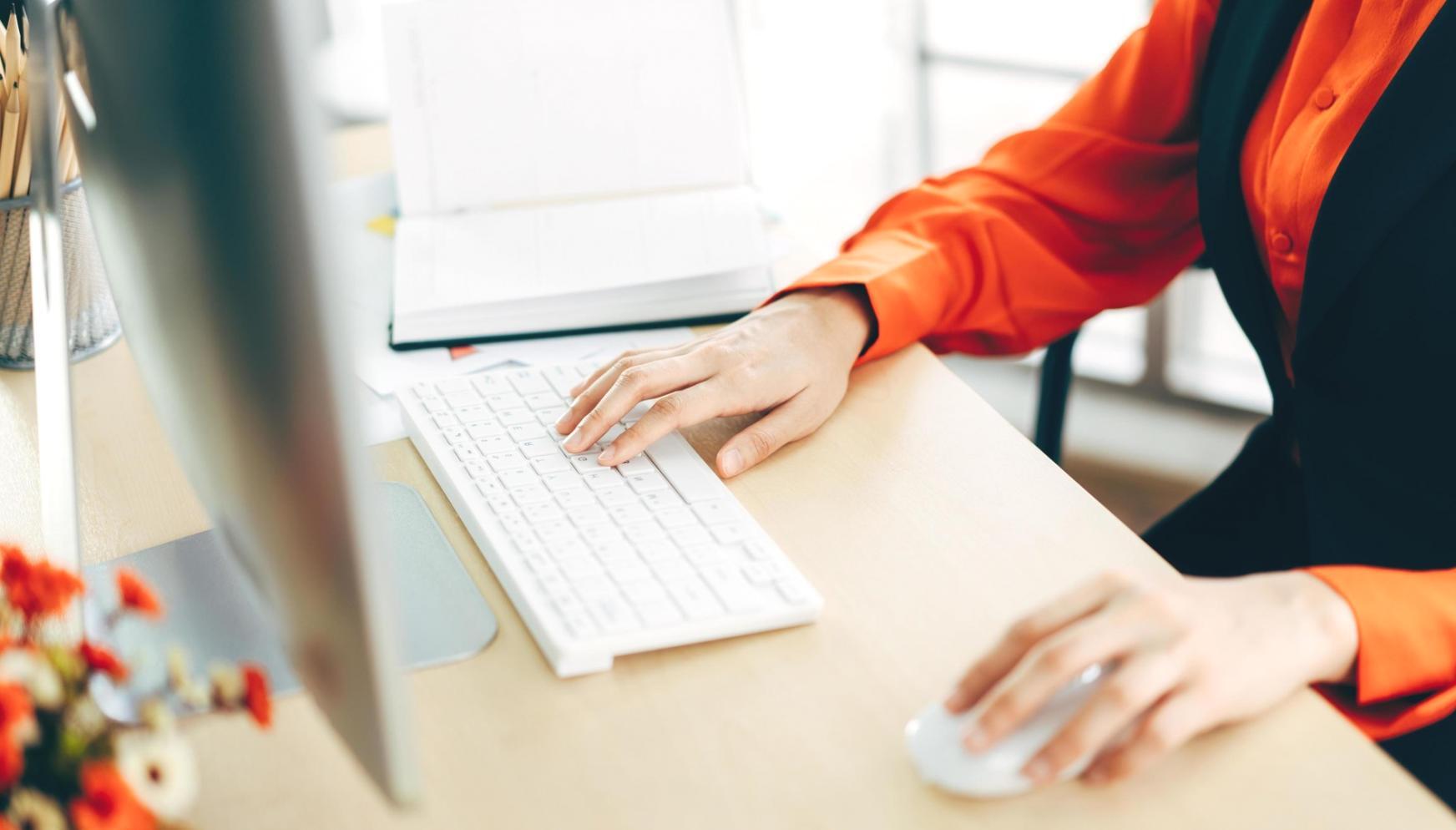 Financial planning workspace with documents and laptop showing investment portfolio